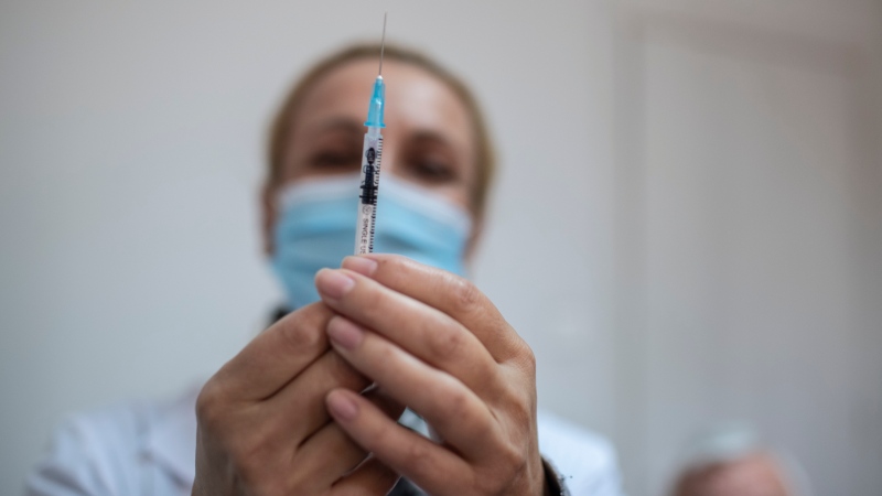 Nurse Loukia Micheli prepares a Pfizer COVID-19 vaccine at a vaccination center in Piraeus, near Athens on Wednesday, March 10, 2021. (AP Photo/Petros Giannakouris) 