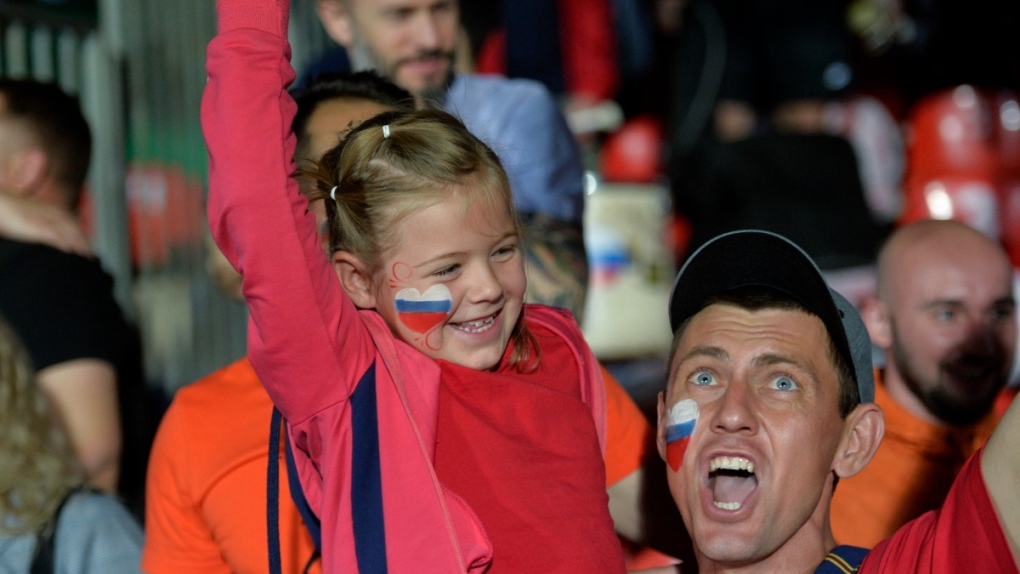 Russian flags painted on the faces of fans