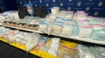 A cache of drugs and guns seized by Toronto police is seen in this image. 