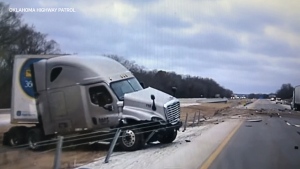 Truck slides through barrier on icy Okla. highway