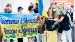 Ukrainian nationals fleeing the ongoing war in Ukraine arrive at Trudeau Airport in Montreal, Sunday, May 29, 2022. THE CANADIAN PRESS/Graham Hughes