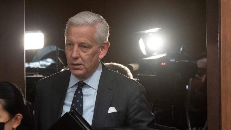 Dominic Barton makes his way past television cameras before appearing as a witness at the Standing Committee on Government Operations and Estimates, Wednesday, February 1, 2023 in Ottawa. The committee is looking into consulting contracts awarded to McKinsey & Co. THE CANADIAN PRESS/Adrian Wyld 