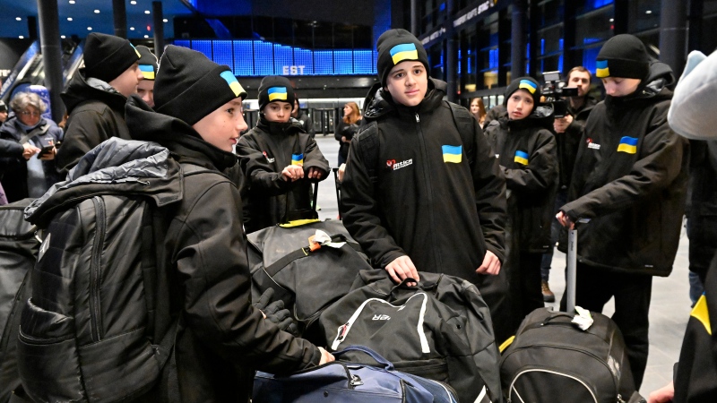 Ukrainian peewee hockey players enter the Videotron Centre, Feb. 1, 2023, in Quebec City. THE CANADIAN PRESS/Jacques Boissinot