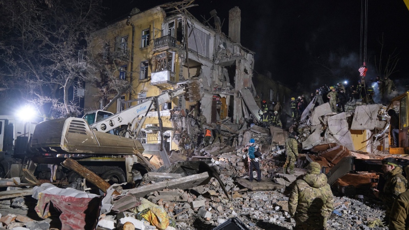 Emergency workers clear the rubble after a Russian rocket hit an apartment building in Kramatorsk, Ukraine, on Thursday, Feb. 2, 2023. At least 3 people were killed and 21 wounded in the attack. (AP Photo/Yevgen Honcharenko)