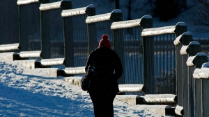 A pedestrian crosses a footbridge along the waterfront in Dartmouth, N.S. on Monday, Jan.7, 2013. (THE CANADIAN PRESS/Andrew Vaughan)