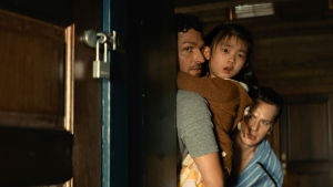 This image released by Universal Pictures shows Ben Aldridge, from left, Kristen Cui, and Jonathan Groff in a scene from "Knock at the Cabin." (Universal Pictures via AP)