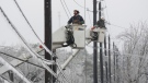 Austin Energy linemen Ken Gray, left, and Chad Sefcik work to restore power on ice-covered lines along West Alpine Road during a winter storm, Wednesday, Feb. 1, 2023, in Austin, Texas. (Jay Janner/Austin American-Statesman via AP)