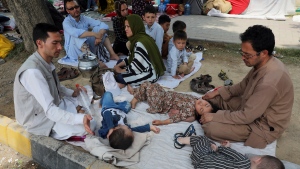 Afghan children sleep as they sit on the ground seeking to receive asylum from the United Nations High Commissioner for Refugees (UNHCR) outside the Islamabad Press Club in Islamabad, Pakistan, Monday, May 9, 2022. (AP Photo/Rahmat Gul)