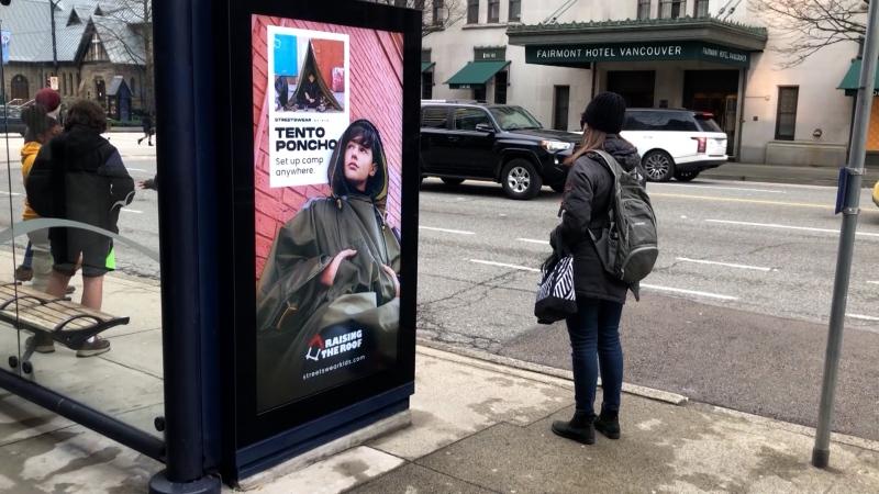 One advertisement found at a bus stop on Vancouver’s busy Burrard Street features a teen in a poncho that doubles as a tent, so that the wearer can “set up camp anywhere.” (CTV)