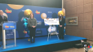 Lottery winner Juliette L. of Sault Ste. Marie (right) stands next to her $48 million cheque presented by OLG. Feb. 3/23 (Chelsea Papineau/CTV Northern Ontario)