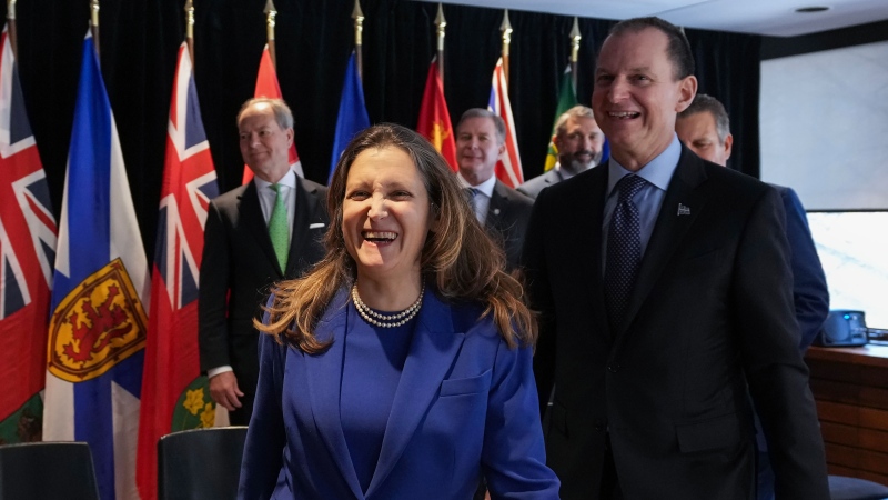 Chrystia Freeland, left, Canada's Deputy Prime Minister and Minister of Finance laughs next to Eric Girard, right, Minister of Finance of Quebec after a group photograph during the Finance Ministers' Meetings in Toronto, on Friday, February 3, 2023. THE CANADIAN PRESS/Nathan Denette