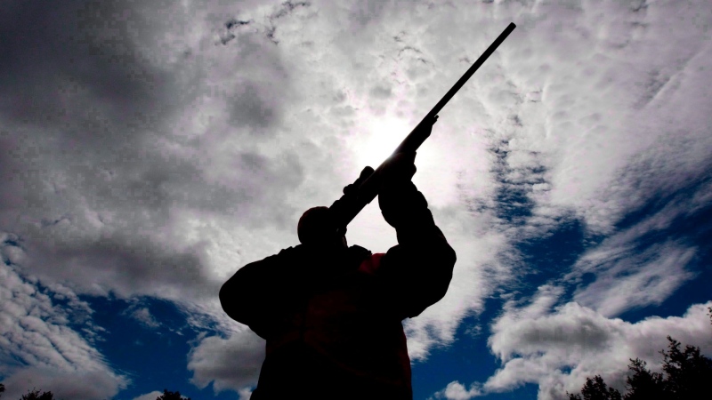 A rifle owner checks the sight of his rifle at a hunting camp property in rural Ontario, west of Ottawa, on Sept. 15, 2010. THE CANADIAN PRESS/Sean Kilpatrick