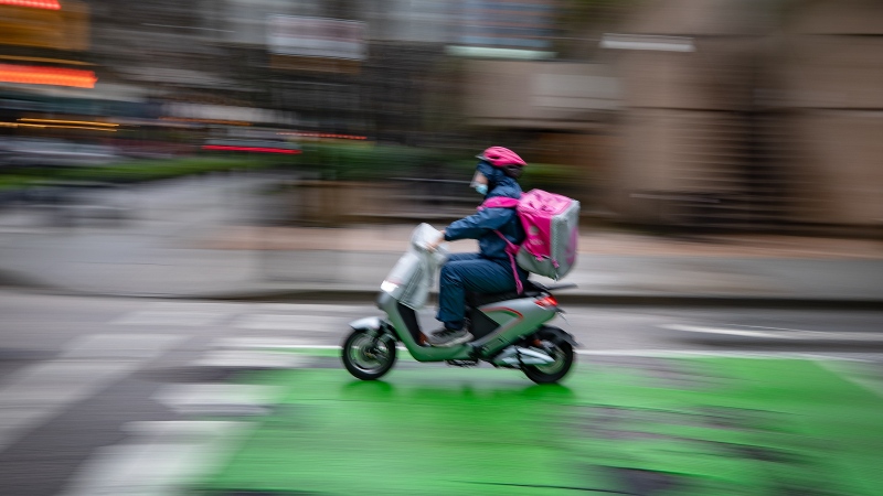A food delivery worker rides an electric bike in downtown Vancouver, on Tuesday, January 12, 2021. THE CANADIAN PRESS/Darryl Dyck