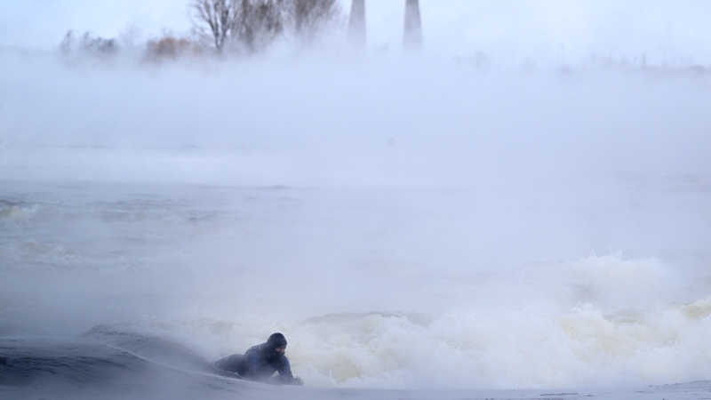 Carlos Hebert Plante boogie boards on the St. Lawrence River in Montreal on Friday, February 3, 2023. Carlos Hebert Plante boogie boards all year even on days like today where the temperature dipped to -26 C. THE CANADIAN PRESS/Bernard Brault