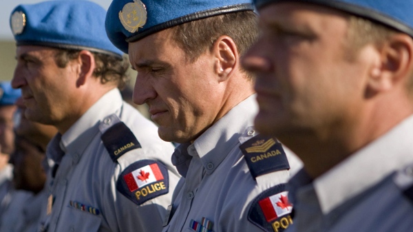 Canadian UN police officers observe a moment of silence for their fallen fellow Canadian UN police officers Douglas Coats and Mark Gallagher who were repatriated from Port au Prince, Haiti to Canada, Friday, Jan. 22, 2010. (THE CANADIAN PRESS)  