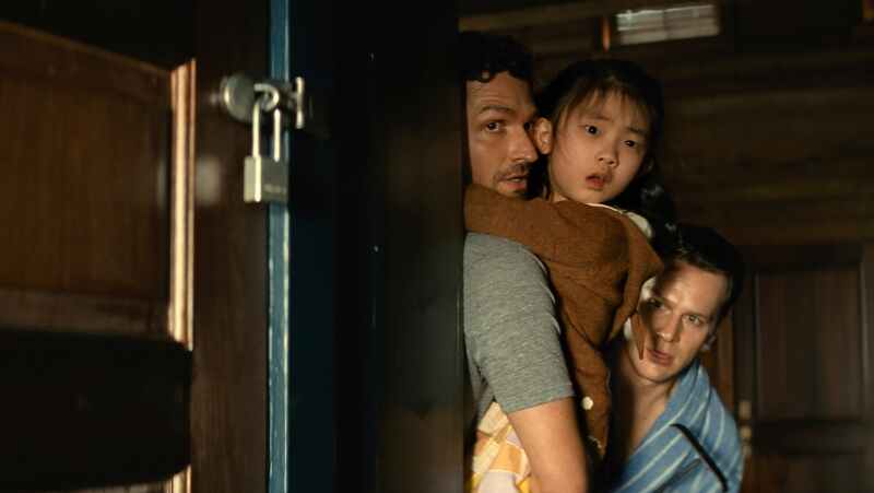 This image released by Universal Pictures shows Ben Aldridge, from left, Kristen Cui, and Jonathan Groff in a scene from "Knock at the Cabin." (Universal Pictures via AP)