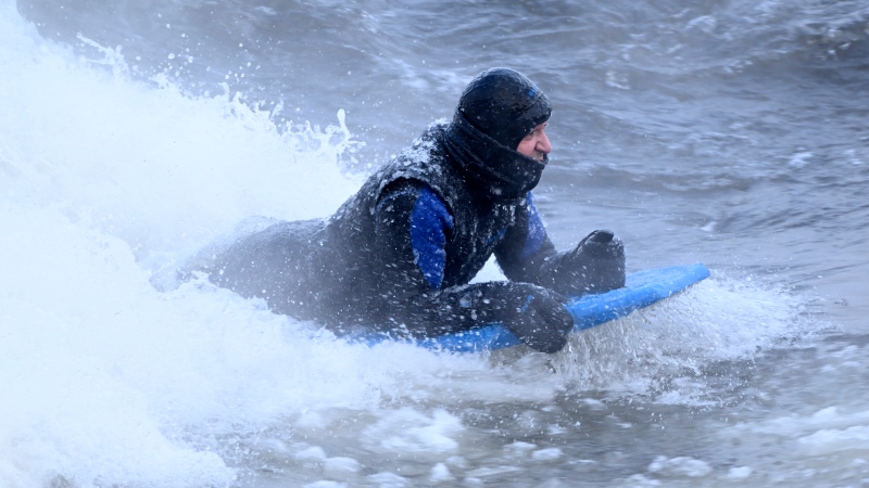 Carlos Hebert Plante boogie boards on the St. Lawrence River in Montreal on Friday, February 3, 2023. Carlos Hebert Plante boogie boards all year even on days like today where the temperature dipped to -26 C. THE CANADIAN PRESS/Bernard Brault