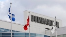 Flags fly outside a Bombardier plant in Montreal, Thursday, November 8, 2018. Bombardier Inc. says it's cutting about 5,000 jobs across the organization over the next 12 to 18 months as part of a new restructuring plan. THE CANADIAN PRESS/Ryan Remiorz