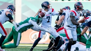 Saskatchewan Roughriders defensive lineman Anthony Lanier II (91) forces Montreal Alouettes quarterback Trevor Harris (7) to fumble the football during first half CFL football action in Regina, on Saturday, July 2, 2022. THE CANADIAN PRESS/Heywood Yu
