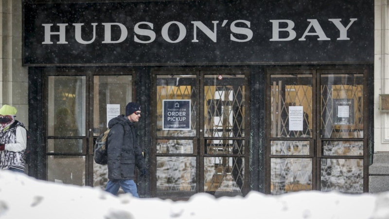 A man walks by a Hudson's Bay location in Calgary, Alta., on March 18, 2020. (THE CANADIAN PRESS/Jeff McIntosh)