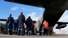 Greek firefighters wait to enter a military plane at Elefsina Air Force Base, in western Athens, Greece, Monday, Feb. 6, 2023. (AP Photo/Thanassis Stavrakis)