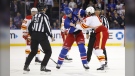 The New York Rangers' Jacob Trouba and the Calgary Flames' Chris Tanev fight during the first period in New York on Feb. 6, 2023. (AP Photo/Noah K. Murray)