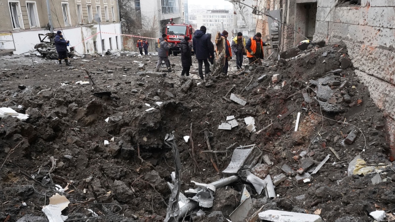 Emergency and municipal workers clear the rubble from a residential building which was hit by a Russian rocket, in the city center of Kharkiv, Ukraine, Sunday, Feb. 5, 2023. (AP Photo/Andrii Marienko)