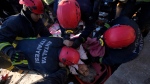 Rescue teams evacuate a survivor from the rubble of a destroyed building in Kahramanmaras, southern Turkiye, Tuesday, Feb. 7, 2023.  (AP Photo/Khalil Hamra)