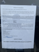 A notice of distress taped to the door of Highbridge Construction's storefront on St. Joseph Boulevard in Ottawa. (Graham Richardson/CTV News Ottawa)
