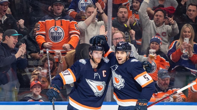 Edmonton Oilers' Connor McDavid (97) and Cody Ceci (5) celebrate a goal against the Chicago Blackhawks during second period NHL action in Edmonton on Saturday January 28, 2023.THE CANADIAN PRESS/Jason Franson