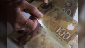 Canadian $100 bills are counted in Toronto on Tuesday, Feb. 2, 2016. THE CANADIAN PRESS/Graeme Roy