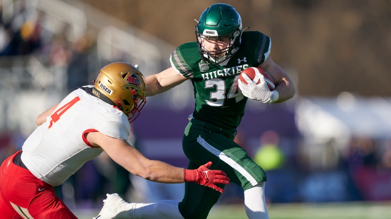 Ryker Frank of the Saskatchewan Huskies tries to avoid a tackle by Laval’s Thomas Landry during the first half of the Vanier Cup in London, Ont., Saturday, Nov. 26, 2022. THE CANADIAN PRESS/Geoff Robins