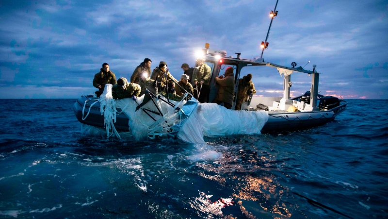 Sailors assigned to Explosive Ordnance Disposal Group 2 recover debris from a high-altitude surveillance balloon off the coast of Myrtle Beach, South Carolina, on February 5. (Petty Officer 1st Class Tyler Thompson/US Navy)