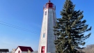 The Port Burwell Lighthouse is seen fenced off for safety in Port Burwell, Ont. on Wednesday, February 8, 2023. (Sean Irvine/CTV News London)
