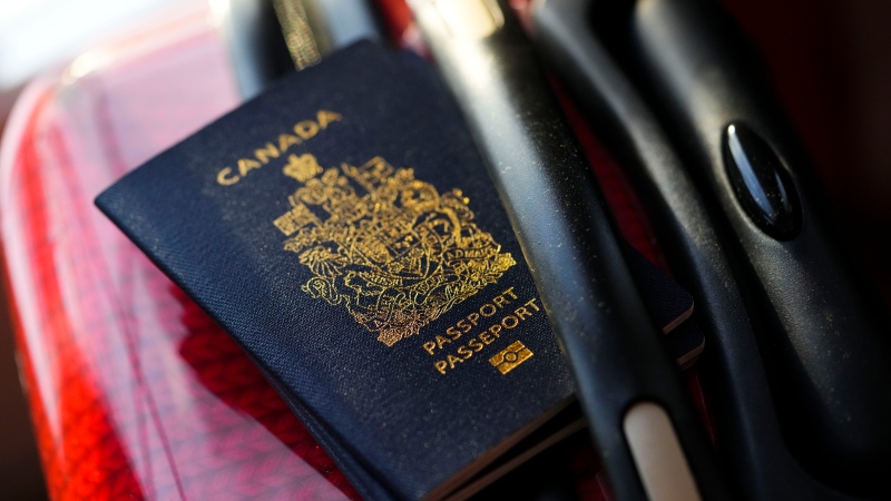 A Canadian passport sits on a suitcase in Ottawa on Tuesday, Jan. 17, 2023. THE CANADIAN PRESS/Sean Kilpatrick