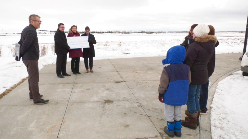 MLA Tanya Fir presents members of the Calgary Centre of the Royal Astronomical Society of Canada $125,000 for its new observatory.