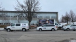 Vehicles from a restoration company are parked outside the Sydney Academy in Sydney, N.S., on Feb. 8, 2023. (Kyle Moore/CTV) 