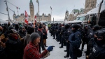 Police move in to clear downtown Ottawa near Parliament hill of protesters after weeks of demonstrations on Saturday, Feb. 19, 2022. The much-anticipated public inquiry into the federal government's unprecedented use of the Emergencies Act during “Freedom Convoy” protests last winter begins Thursday. THE CANADIAN PRESS/Cole Burston