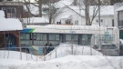 A city bus is shown next to a daycare centre in Laval, Que, Wednesday, February 8, 2023, where the driver crashed it into the building leaving two children dead. THE CANADIAN PRESS/Graham Hughes 