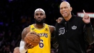 Los Angeles Lakers forward LeBron James, left, poses with after passing Abdul-Jabbar to become the NBA's all-time leading scorer during the second half of an NBA basketball game against the Oklahoma City Thunder Tuesday, Feb. 7, 2023, in Los Angeles. (AP Photo/Ashley Landis) 