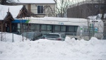 A city bus is shown next to a daycare centre in Laval, Que, Wednesday, February 8, 2023, where the driver crashed it into the building leaving two children dead. THE CANADIAN PRESS/Graham Hughes