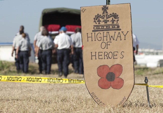 A sign sits at the airport in the military compound as the caskets of two fallen RCMP member leave after a ramp ceremony for two members of the RCMP killed in last weeks earthquake in Port-au-Prince, Haiti, Friday, Jan. 22, 2010. Supt. Doug Coates and Sgt. Mark Gallagher were in Haiti as part of Canada's contribution to the UN stabilization mission. (Adrian Wyld / THE CANADIAN PRESS)  