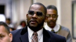 R. Kelly, center, leaves the Daley Center after a hearing in his child support case May 8, 2019, in Chicago. (AP Photo/Matt Marton, File)