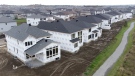 In this photo taken using a drone, homes under construction are seen in a new suburb, Friday, Oct. 15, 2021 in Ottawa. THE CANADIAN PRESS/Adrian Wyld