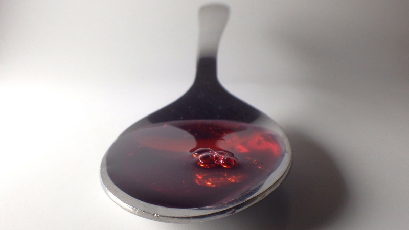 A spoonful of cough syrup is shown in Toronto, Saturday, Jan. 25, 2014. THE CANADIAN PRESS/Graeme Roy 