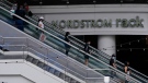People ride an escalator as they shop at the Nordstrom Local DTLA downtown Los Angeles, March 15, 2022. (AP Photo/Damian Dovarganes, File)