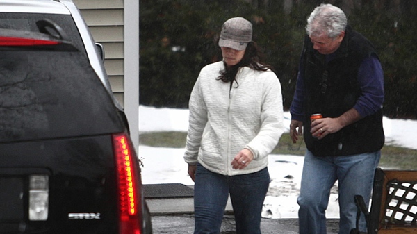 Olympic figure skater Nancy Kerrigan, left, and her husband Jerry Solomon walk toward a vehicle as they depart the home of Kerrigan's parents, in Stoneham, Mass., on Monday, Jan. 25, 2010. (AP / The Boston Globe, Pat Greenhouse)