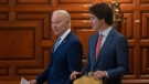 United States President Joe Biden walks past Prime Minister Justin Trudeau as they take their seats for a meeting at the North American Leaders’ Summit on Tuesday, January 10, 2023 in Mexico City, Mexico. THE CANADIAN PRESS/Adrian Wyld