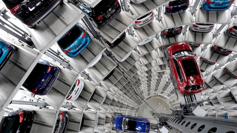In this March 14, 2017 file photo Volkswagen cars are lifted inside a delivery tower of the company in Wolfsburg, Germany. . (AP Photo/Michael Sohn, file)
