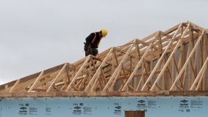 A construction worker works on a house in a new housing development in Oakville, Ont., Friday, April 29. 2011. THE CANADIAN PRESS/Richard Buchan